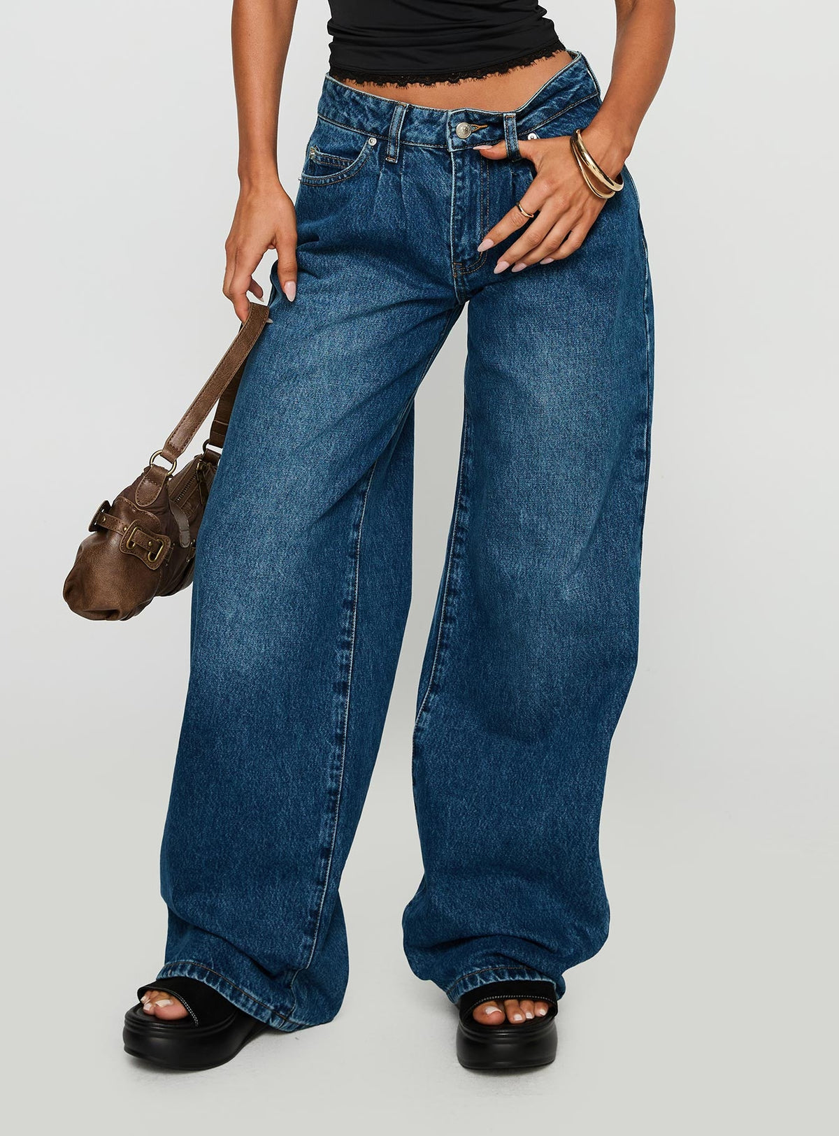 side view of model wearing Princess Polly Duster Oversized Jeans Dark Wash Mid Rise 