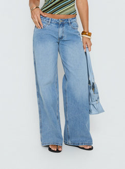 side view of model wearing Princess Polly Ramos Low Rise Wide Leg Denim Jeans Bright Blue Wash Mid Rise Jeans Jeans 