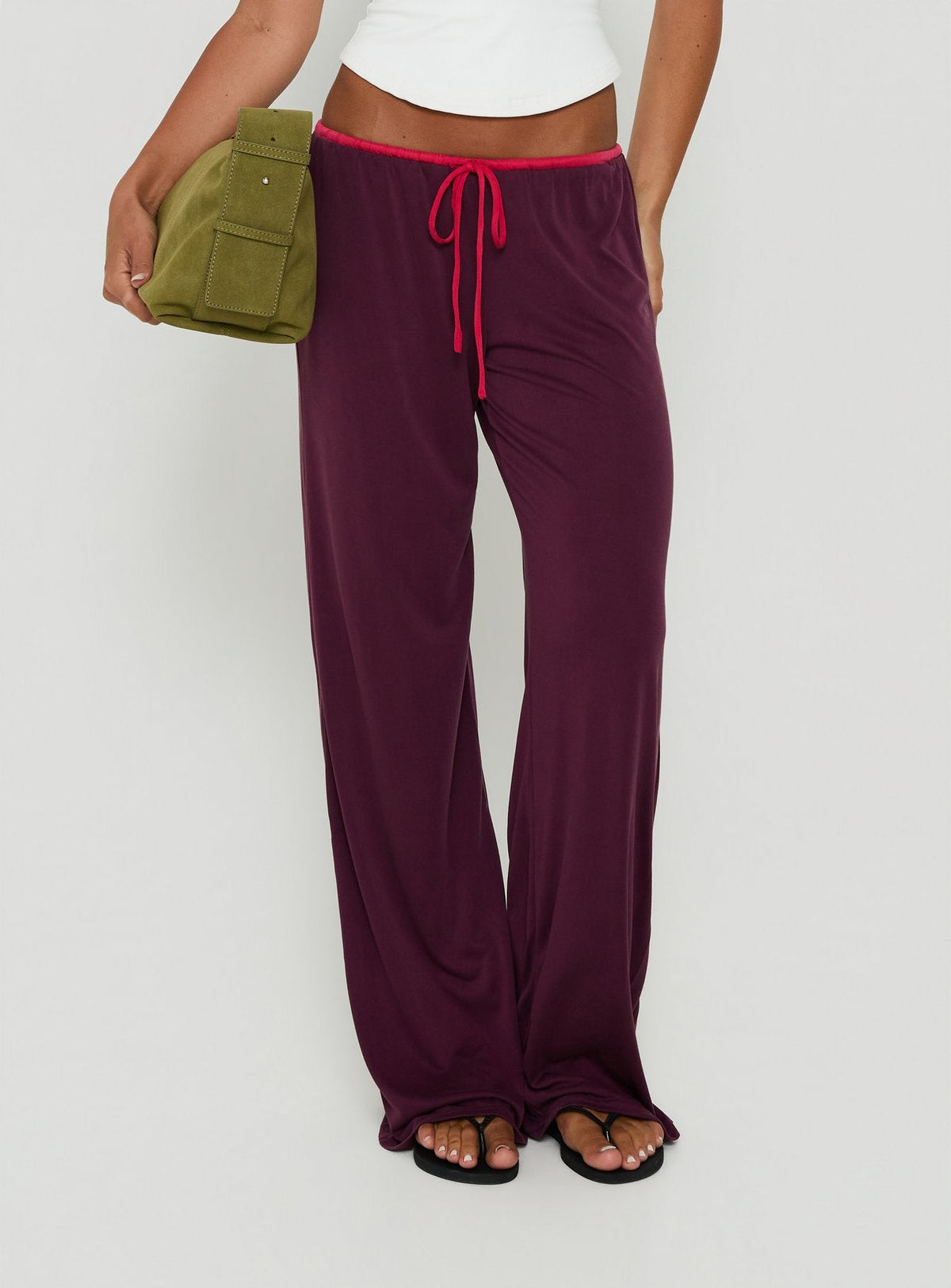 Featuring the Jessika Ultra Low Pants Red / Plum womens-regular-pants in low-rise style detail view of model wearing