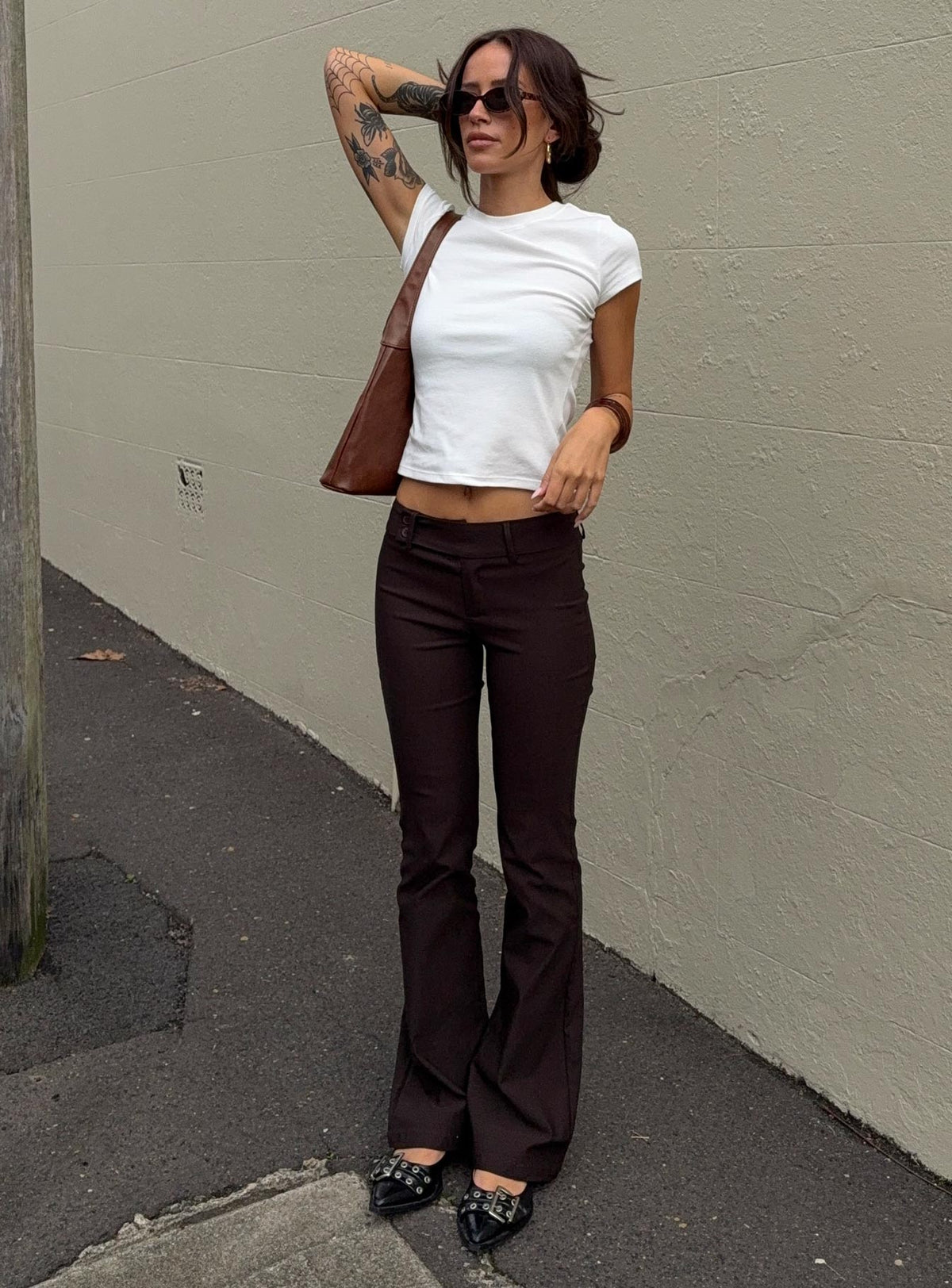 front view of model wearing Princess Polly Kinkirk Flared Pants Chocolate Tall Low Rise Pants 