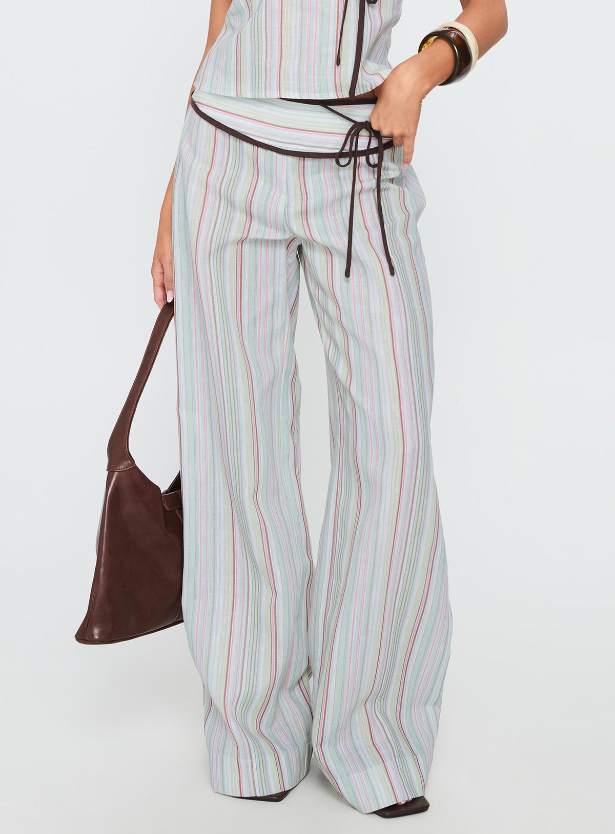 back view of model wearing Princess Polly Taylar Thick Waistband Tie Pants Green Stripe High Waisted Pants 