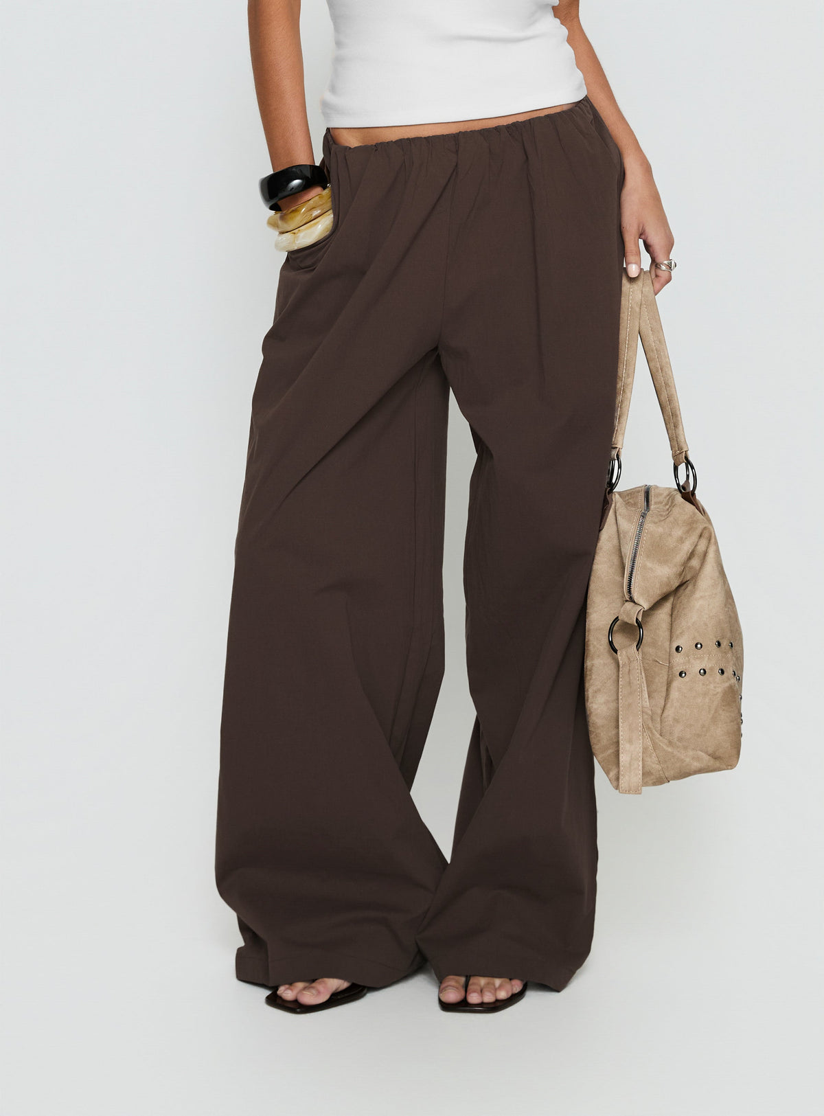 Crafted from the Lunea Concealed Waistband Pants Brown womens-regular-pants featuring mid-rise side view of model wearing Princess Polly