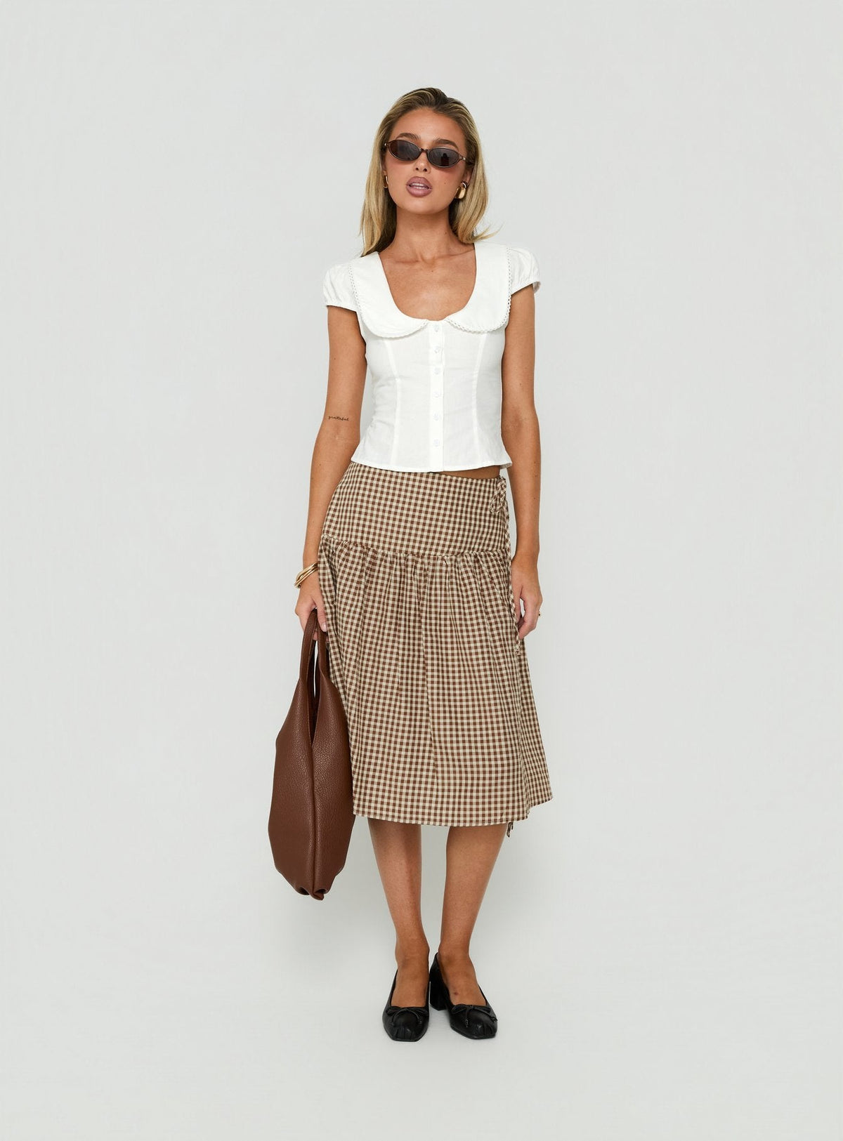 Designed with the Kasida Tie Detail Midi Skirt Brown Check in womens-skirts with midi length side view of model wearing Princess Polly
