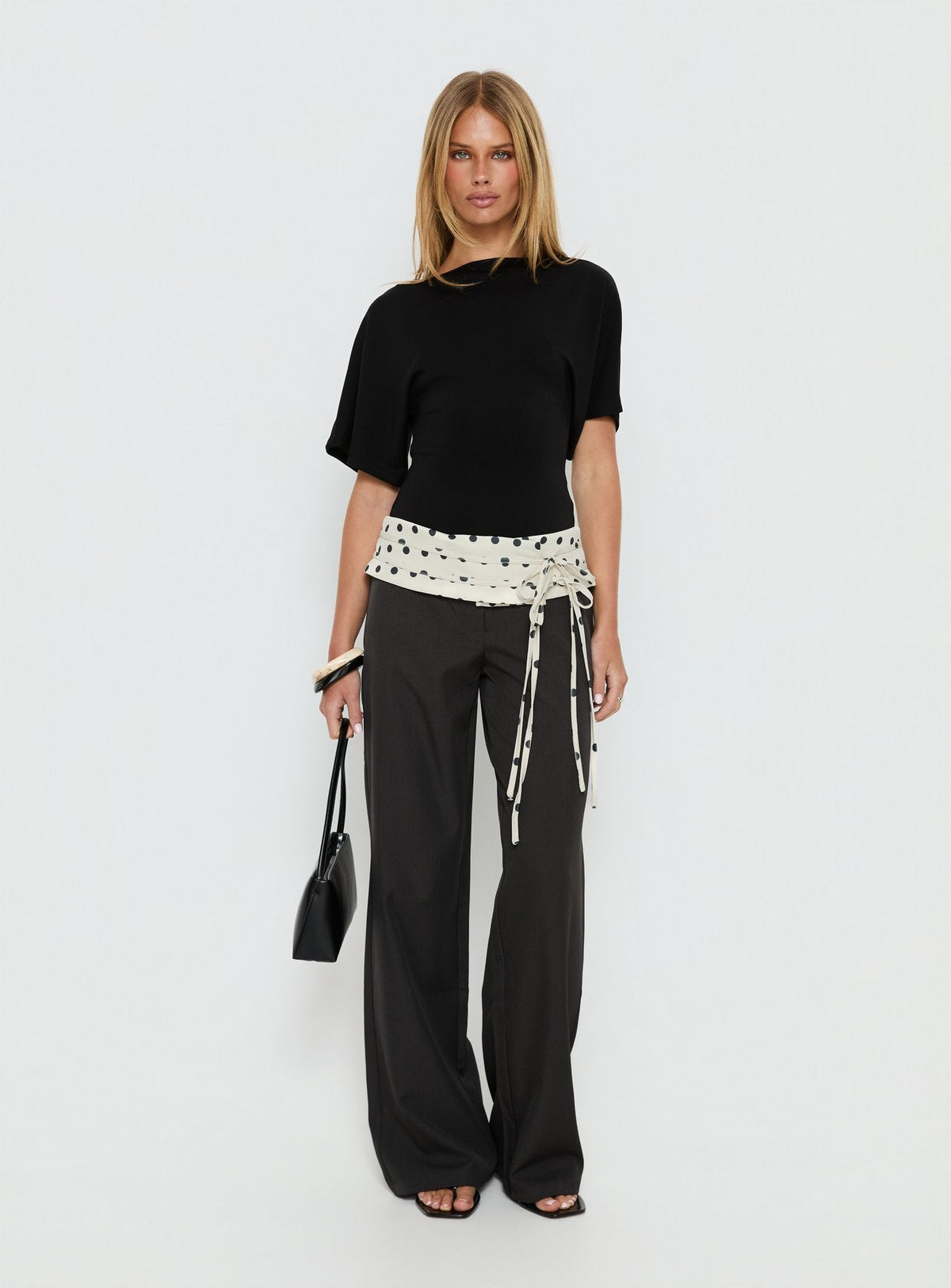 back view of model wearing Princess Polly Seneca Wrap Pants Charcoal Polka Dot Mid Rise Pants 