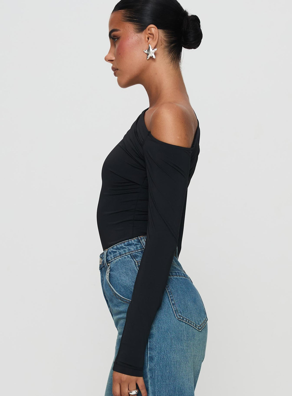 side view of model wearing Princess Polly Antilles One Shoulder Bodysuit Black Long Sleeve Tops Bodysuit 