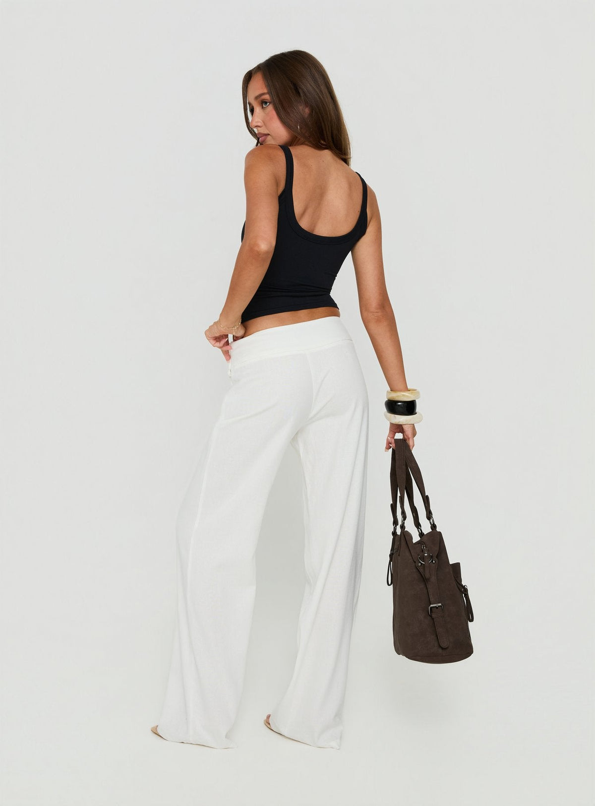 Highlighting the Brea Frill Belted Pants White womens-regular-pants with high-rise back view of model wearing