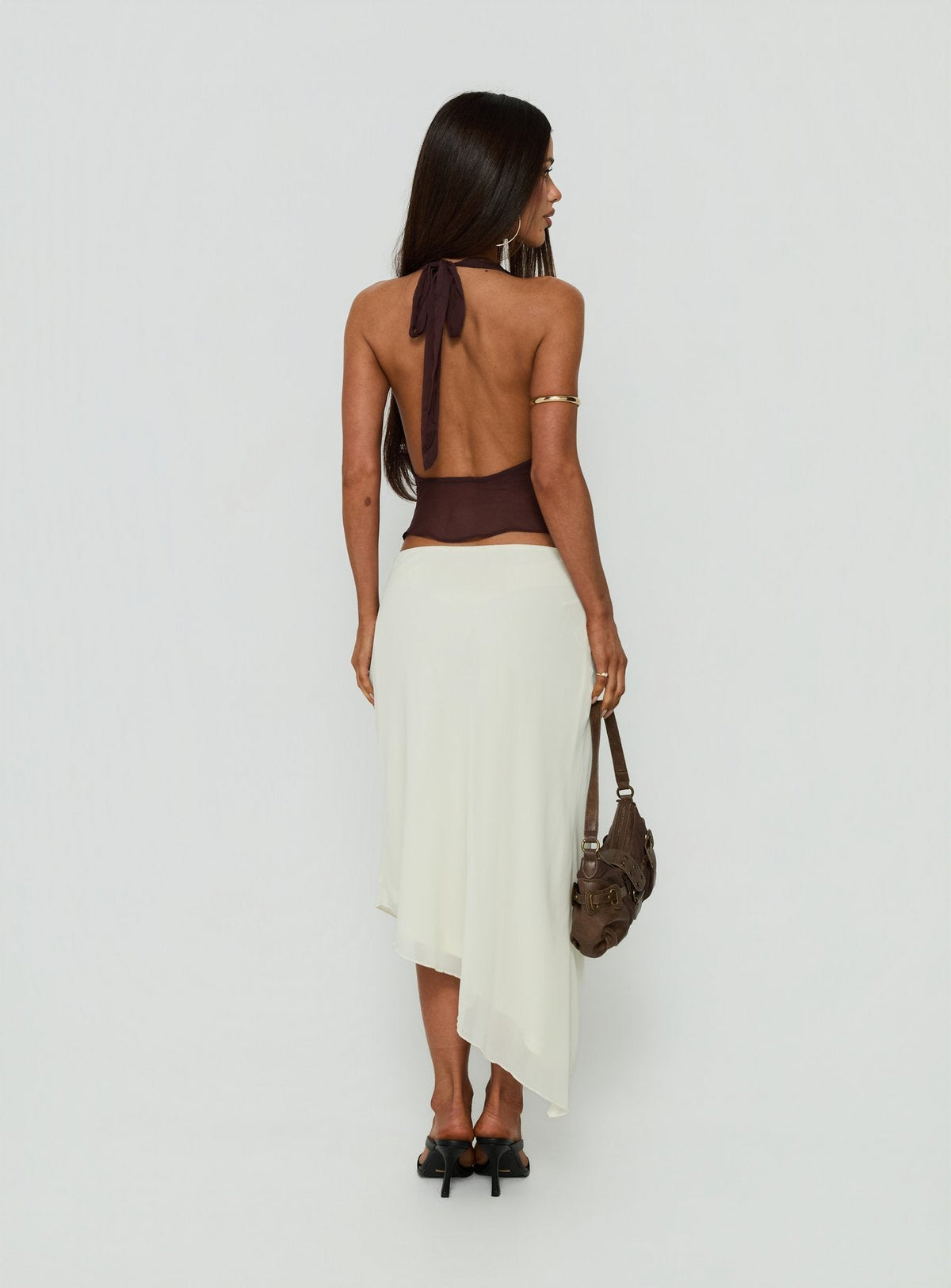 Presenting the Suella Asymmetrical Midi Skirt Off White in womens-skirts with a midi length back view of model wearing Princess Polly