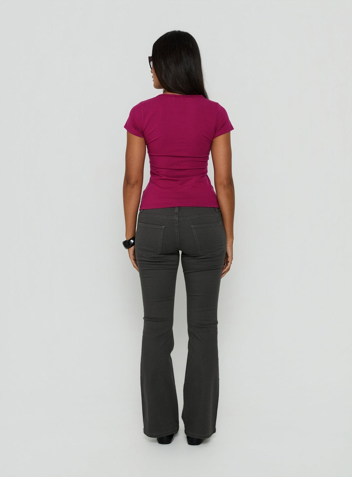 Styled in a low rise design, the Trust Fund Bootleg Cargo Pants Charcoal in womens regular pants, back view of model wearing Princess Polly