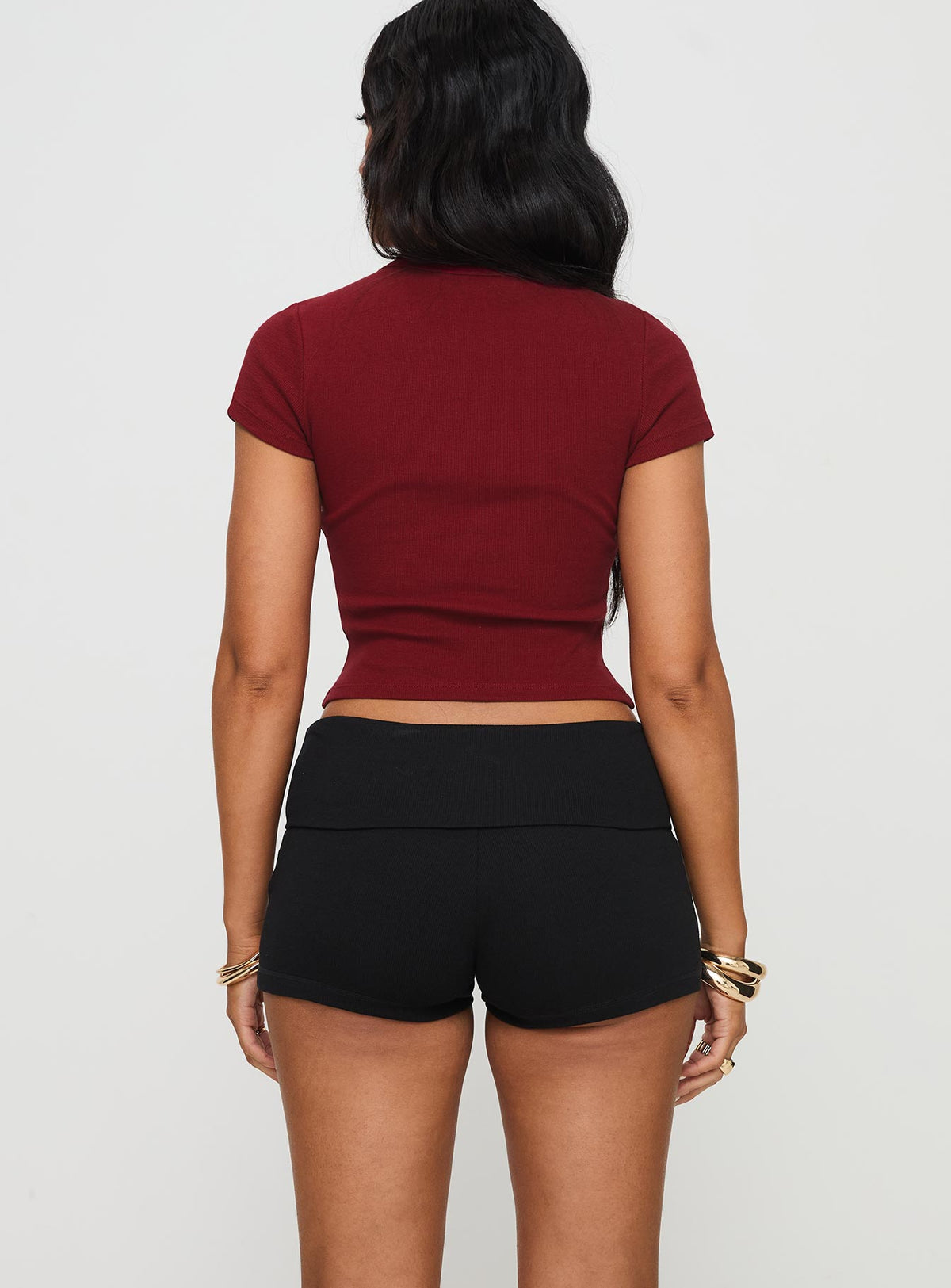 back view of model wearing Princess Polly Baseline Low Rise Rib Shorts Black High Waisted Shorts 