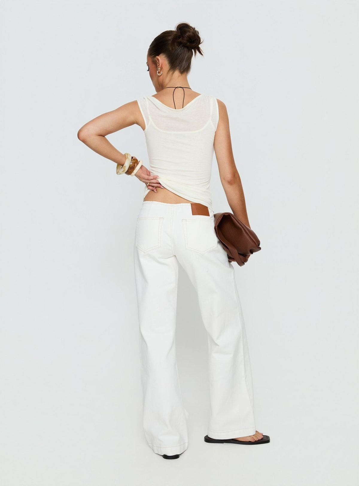 back view of model wearing Princess Polly Buenos No Waist Low Rise Straight Leg Jeans White Mid Rise Jeans 