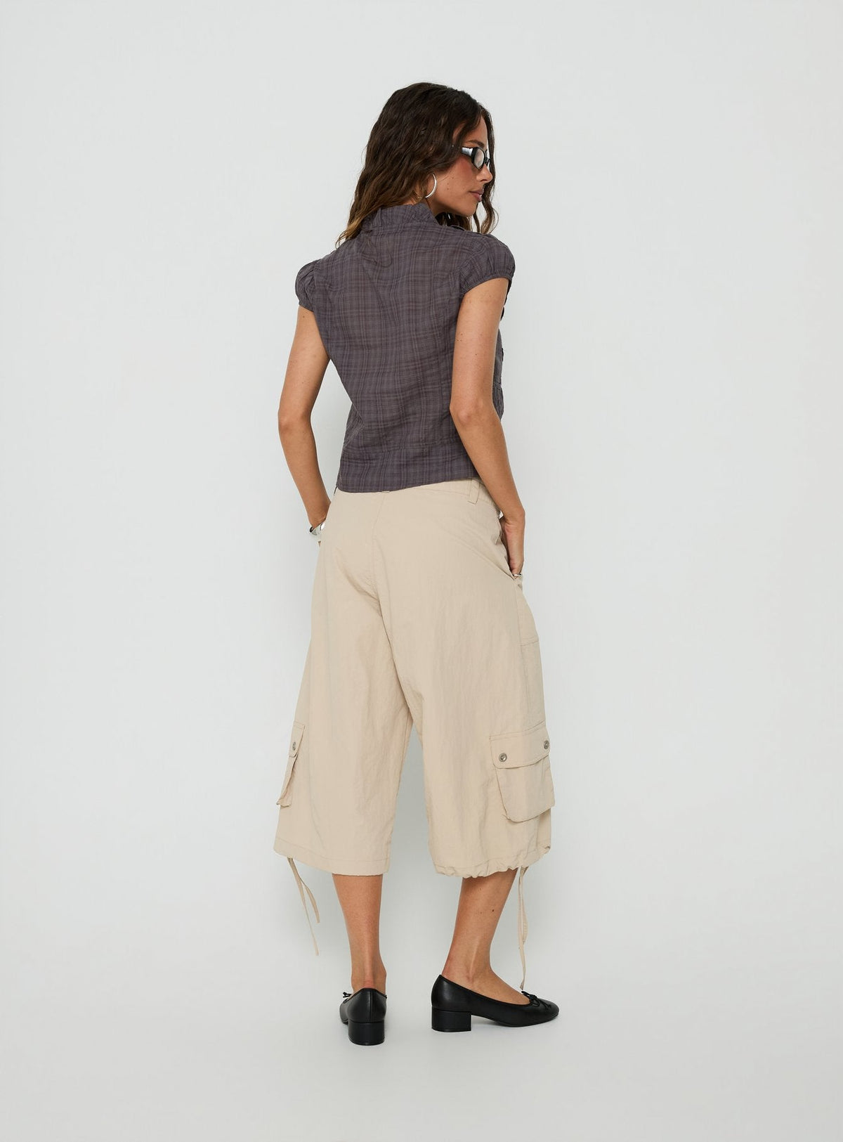 Presenting the Relaxer 3/4 Cargo Pants Beige in womens regular pants with mid-rise back view of model wearing Princess Polly