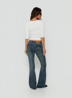 Showcasing the Clynee Ultra Low Rise Bootleg Jeans Dirty Blue in womens-jeans back view of model wearing Princess Polly