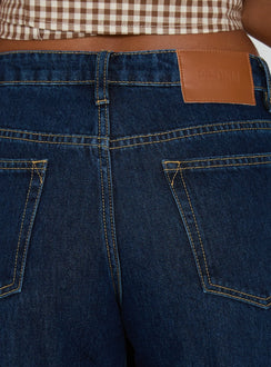 back view of model wearing Princess Polly Darla Low Rise Straight Leg Cuff Jean Dark Blue Wash Low Rise Jeans Jeans 