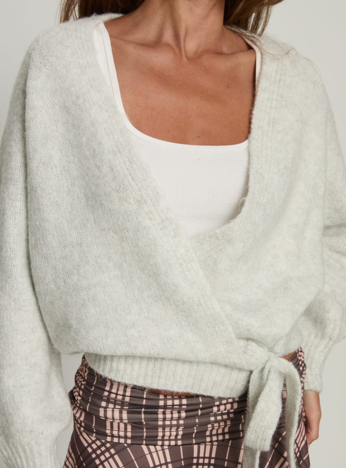 front view of model wearing Princess Polly Daelan Wrap Knit Cardigan Grey Marle Cropped Jumpers Jumpers 