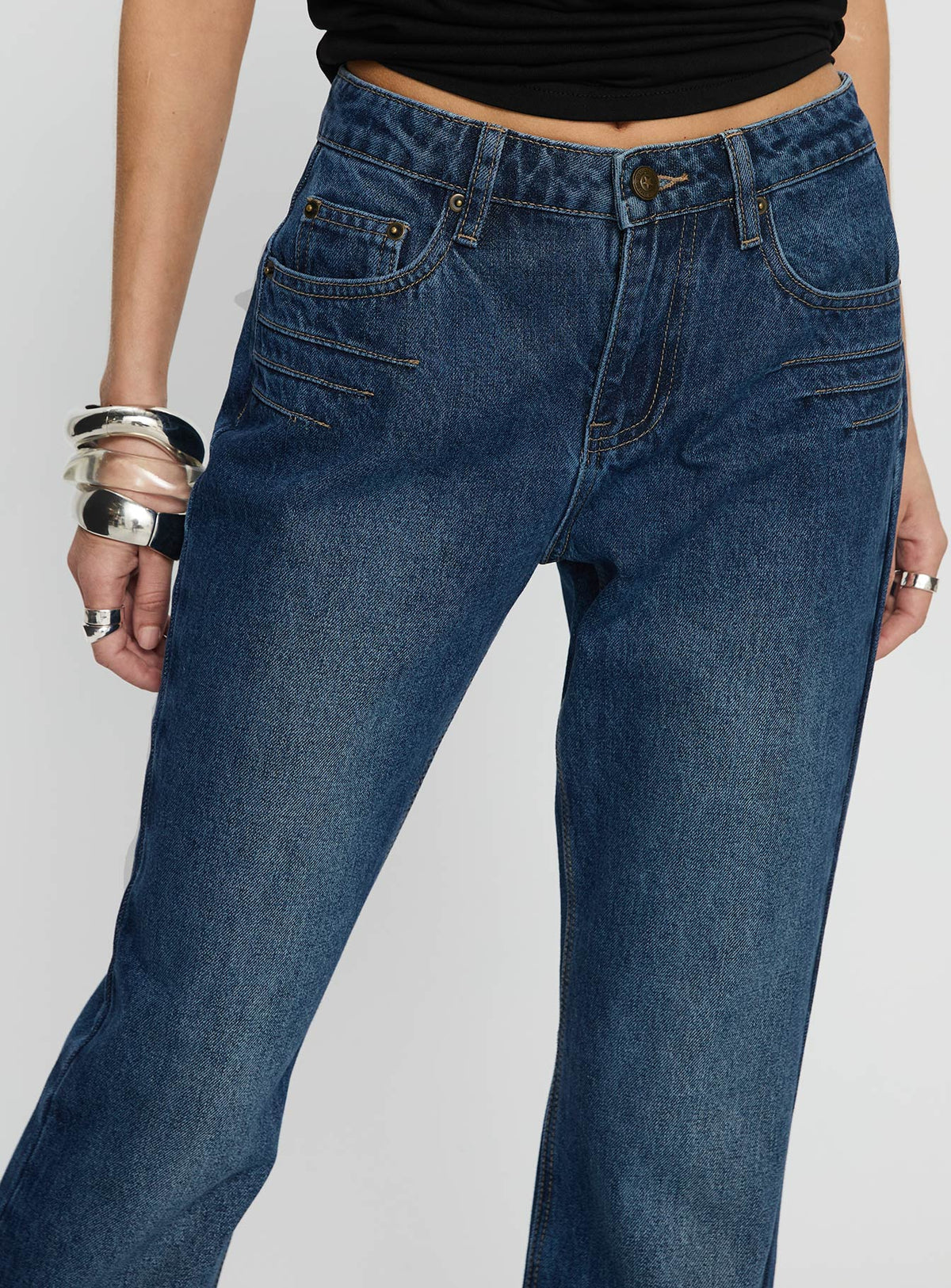 back view of model wearing Princess Polly Wide World Mid Rise Bootleg Jeans Mid Blue Mid Rise Jeans 