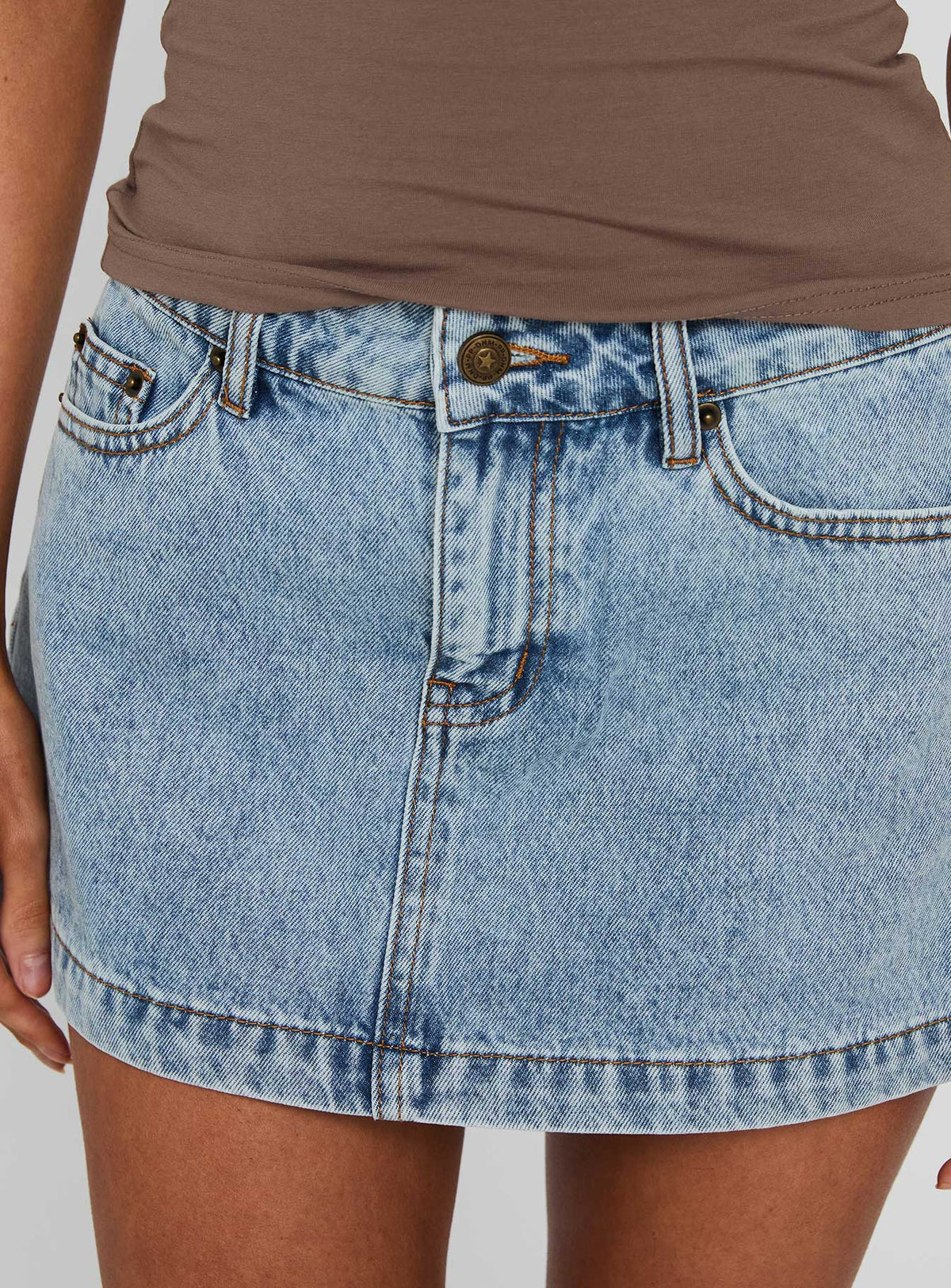 back view of model wearing Princess Polly Nicolina Low Rise Denim Mini Skirt Ice Blue Wash Mini Skirts 