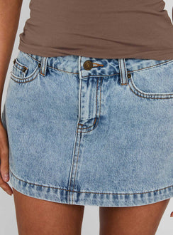back view of model wearing Princess Polly Nicolina Low Rise Denim Mini Skirt Ice Blue Wash Mini Skirts 