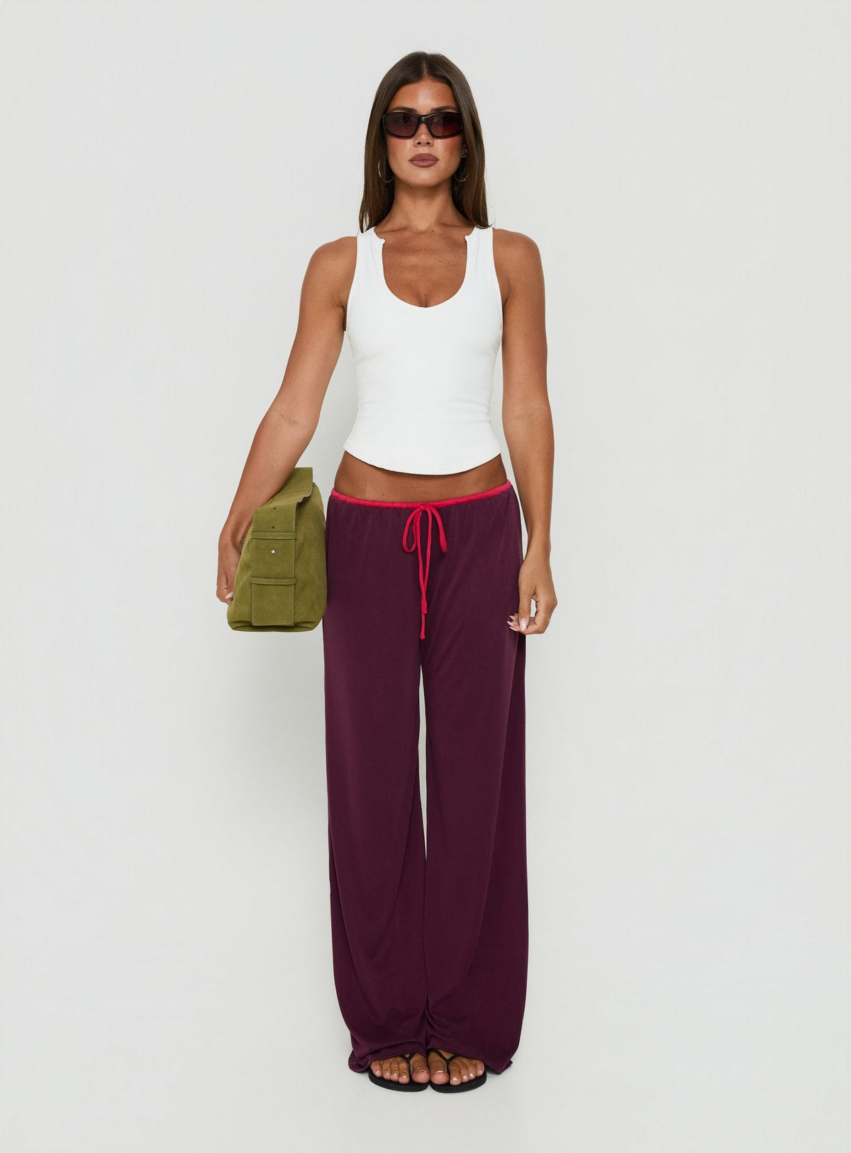 Showcasing the Jessika Ultra Low Pants Red / Plum womens-regular-pants with low-rise design front view of model wearing