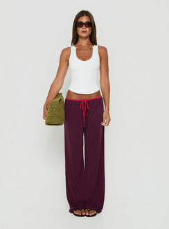 Showcasing the Jessika Ultra Low Pants Red / Plum womens-regular-pants with low-rise design front view of model wearing