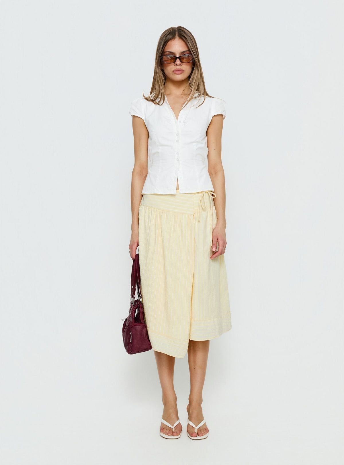   side view of model wearing Princess Polly Sunney Wrap Midi Skirt Yellow Midi Skirts Skirts 