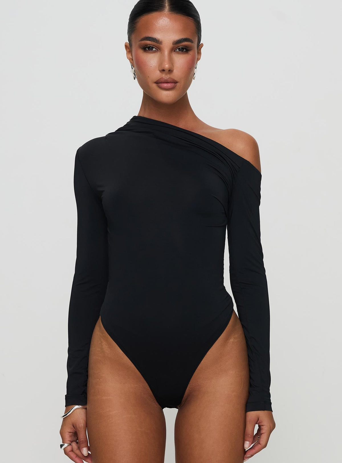front view of model wearing Princess Polly Antilles One Shoulder Bodysuit Black Long Sleeve Tops Bodysuit 