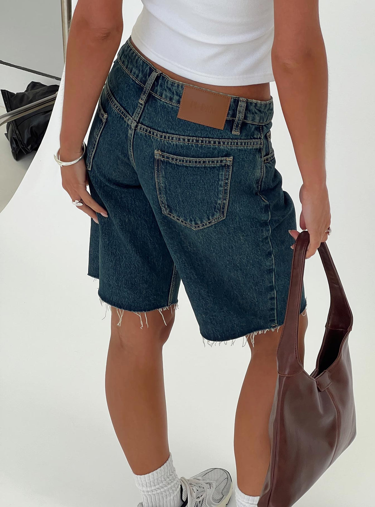 back view of model wearing Princess Polly Cult Classic Longline Denim Shorts Vintage Wash Low Rise Shorts 
